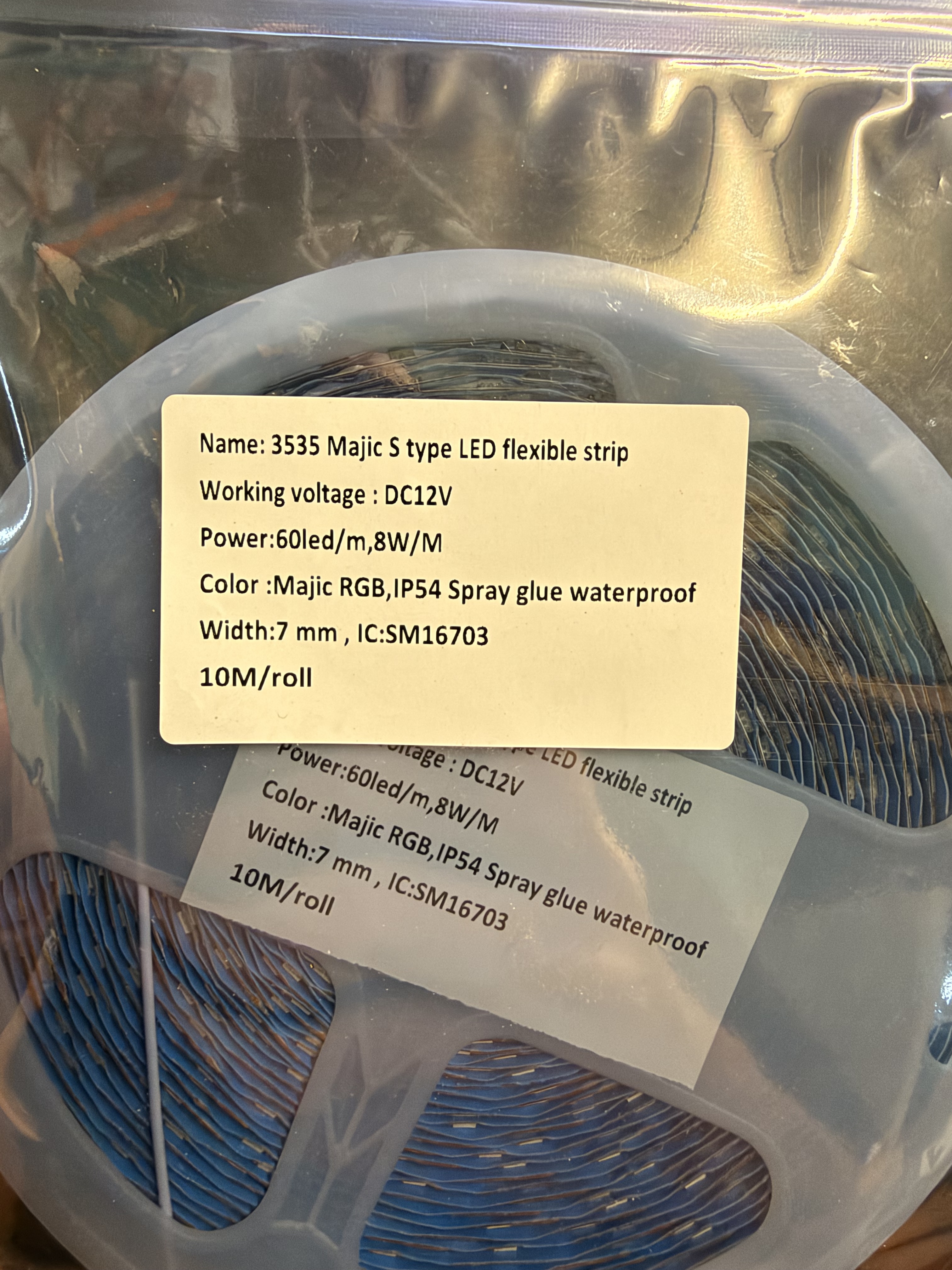 Original photo of the 10 m Magic RGB LED strip reel inside its silver pouch, with specification label